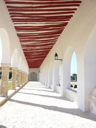 an arcade with a wooden ceiling in a building at Mayaland Hotel & Bungalows in Chichén-Itzá