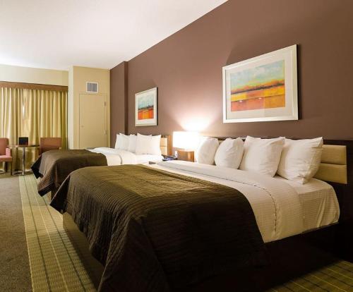 a hotel room with two large beds in it at Hotel Casino New Nouveau Brunswick in Moncton