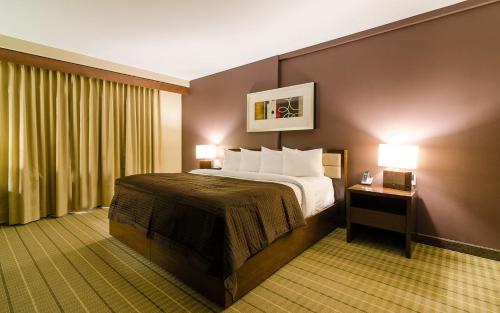 a hotel room with a bed and a window at Hotel Casino New Nouveau Brunswick in Moncton