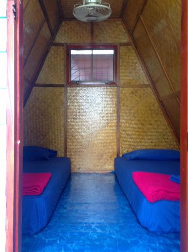 a room with two blue beds in a tent at New Hut Bungalow in Lamai