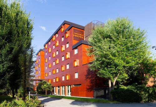 an orange building with trees in front of it at Antony Hotel - Venice Airport in Campalto