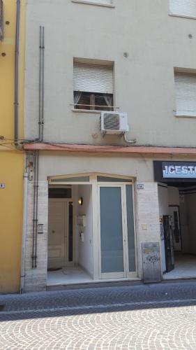 a building with a door and a heater on top of it at Casa Cavour in Pesaro