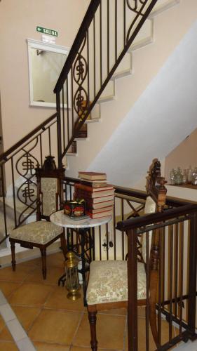 a room with a staircase with a table and books at La Posada Del Infante in La Puebla de los Infantes