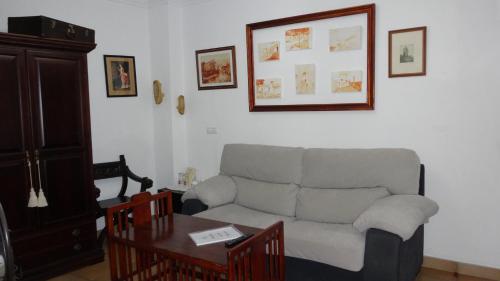 a living room with a couch and a table at La Posada Del Infante in La Puebla de los Infantes