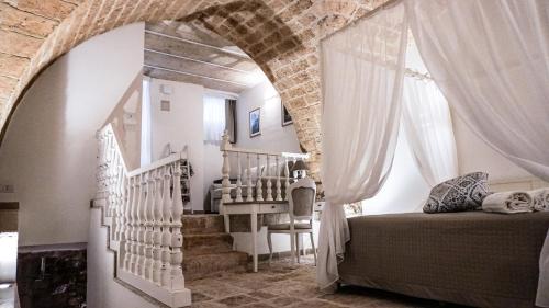 a bedroom with a bed and stairs in a room at L'IMPERATORE Relax & Charme in Altamura