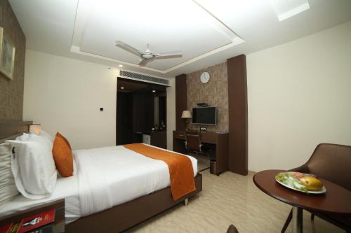Ein Bett oder Betten in einem Zimmer der Unterkunft Hotel Indraprasttha