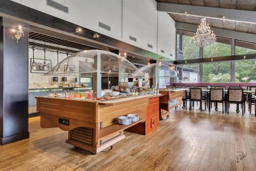 a restaurant with a counter with chairs and tables at Nordfjord Hotell in Nordfjordeid