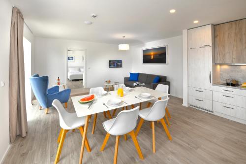 a dining room and living room with a table and chairs at Zlatni Zalaz,Apartments,Supetarska Draga in Supetarska Draga