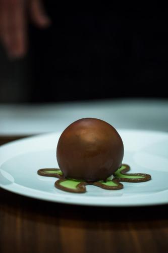 a chocolate dessert on a white plate on a table at Logis Hôtel et Spa Chez Camillou in Aumont-Aubrac