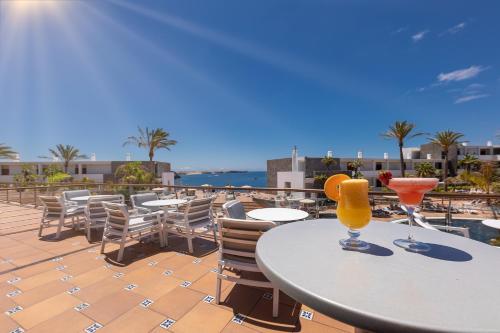 two drinks on a table on a balcony at Hotel Mirador Papagayo by LIVVO in Playa Blanca