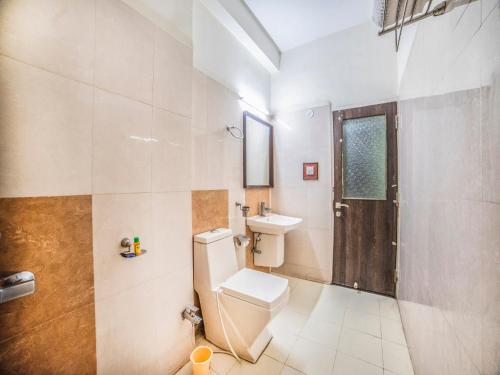 a bathroom with a toilet and a sink at FabHotel Santoor Geeta Bhawan Square in Indore