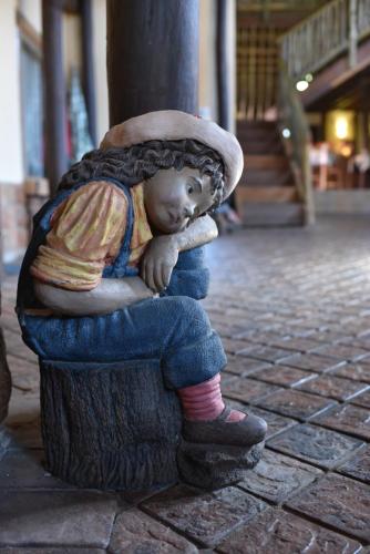a statue of a child sitting on a stump at The Cedars Bed and Breakfast in Centurion