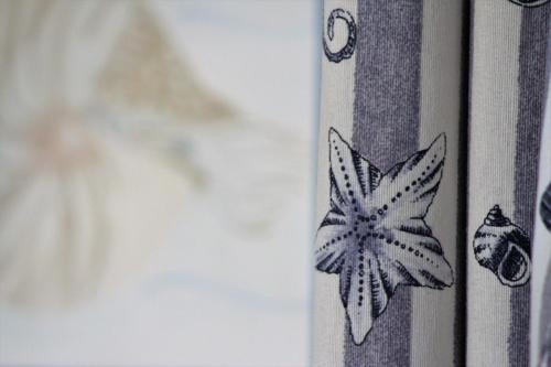 a close up of a butterfly on a curtain at Glafki in Limne