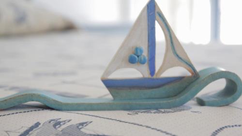 a small toy boat sitting on top of a table at Glafki in Limne