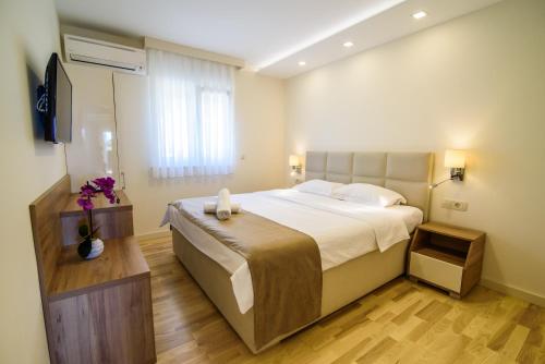 Giường trong phòng chung tại Apartments Leone Lukas