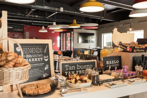 a bakery with a table with bread and pastries on it at Ibis Madrid Fuenlabrada in Fuenlabrada