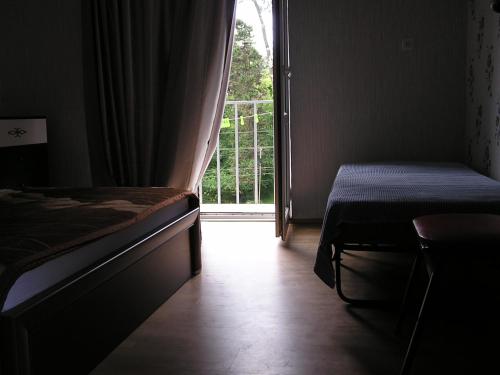 a bedroom with a bed and a door to a balcony at Private Cottage at the Black sea in Shekvetili