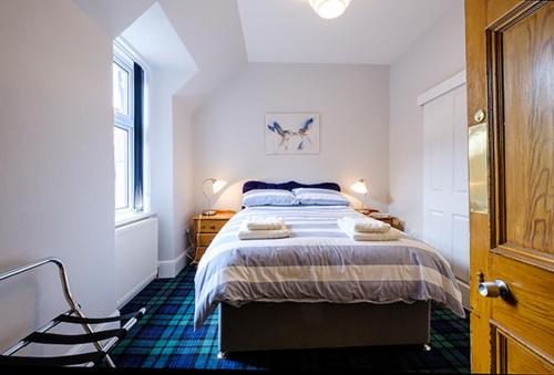 a bedroom with a bed with towels on it at Eastdene Guest House in Inverness