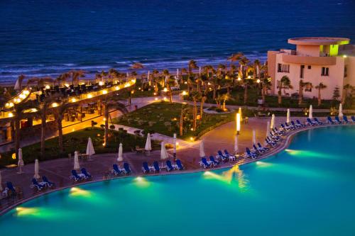 a view of a resort with a pool at night at Grand Ocean El Sokhna in Ain Sokhna