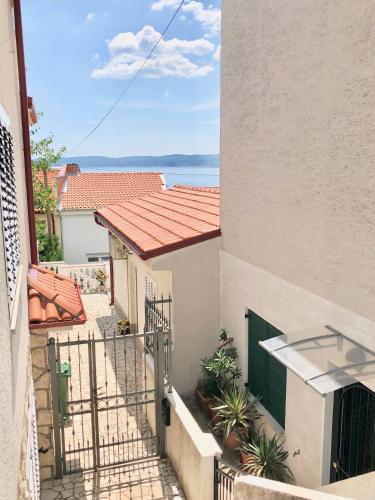 a balcony of a building with a view of the ocean at Ana s garden appartment in Selce