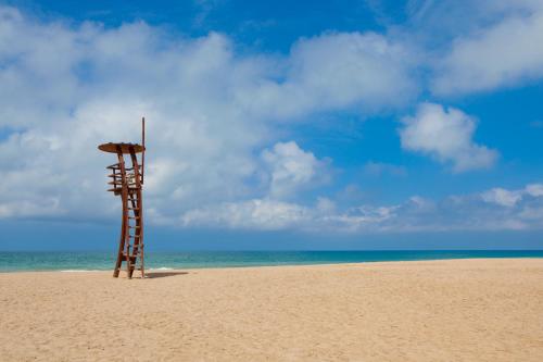 a life guard stand on a beach with the ocean at Hotel & Spa Peñiscola Palace in Peñíscola