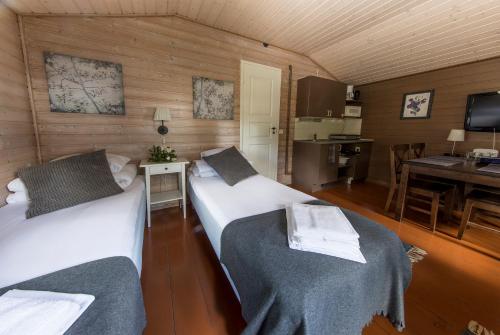 Ένα ή περισσότερα κρεβάτια σε δωμάτιο στο Santalahti Resort Cottages & Villas