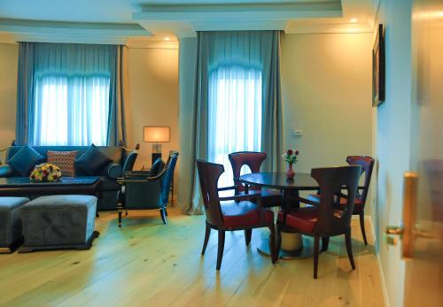 a living room with a table and chairs and a couch at Swiss Inn Nexus Hotel in Addis Ababa
