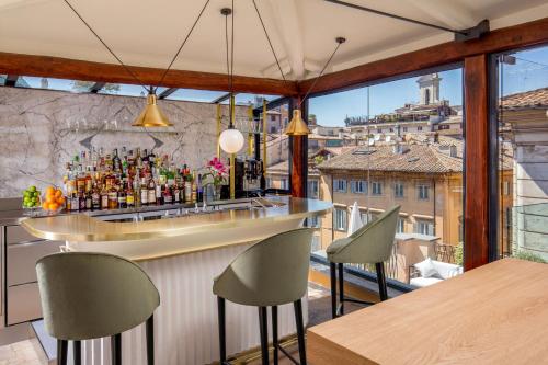 a bar in a restaurant with a view of the city at 9Hotel Cesari in Rome