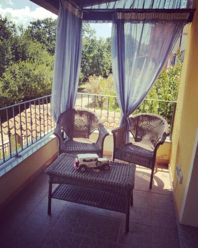 a toy car sitting on a bench on a balcony at B&B 500 Miglia  in Tempio Pausania
