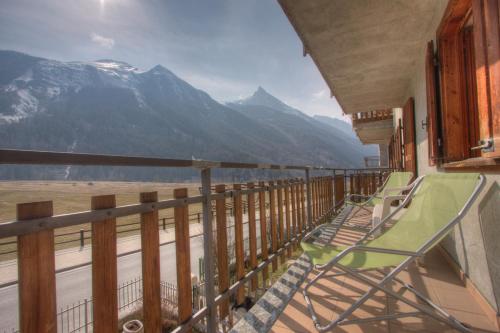 a balcony with chairs and a view of a mountain at La Maison De Chouflette in Cogne