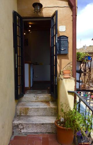 an open door to a building with stairs and plants at Casa SoleLuna in Calcata