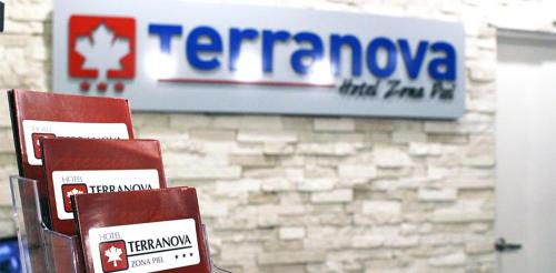 a sign for a temagenova store with two red chairs at Hotel Terranova in León