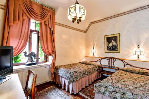 a bedroom with two beds and a window at Park Hotel Turku in Turku