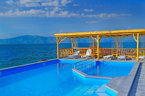 a swimming pool on the edge of the ocean at Tsovasar Family Rest Complex in Sevan