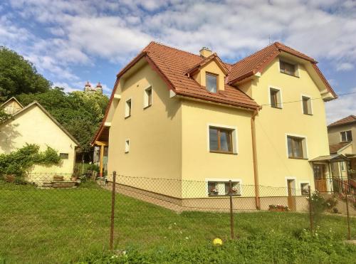 a large yellow house with a red roof at Apartman pod Kalváriou - rodinný dom in Banská Štiavnica