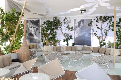 a room with white furniture and posters on the wall at Bab Hotel in Marrakech