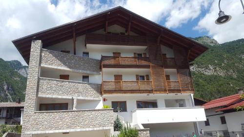 budynek z drewnianymi balkonami na górze w obiekcie Hotel Pramaggiore w mieście Forni di Sotto