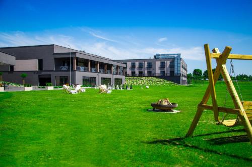a building with a yard with chairs and a building at Hotel Rondo in Wąbrzeźno