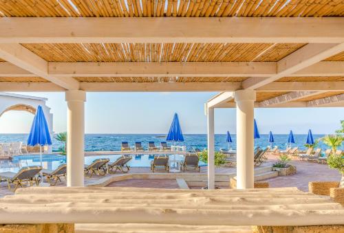 a pavilion with a view of the beach and the ocean at Pyrgos Blue in Malia