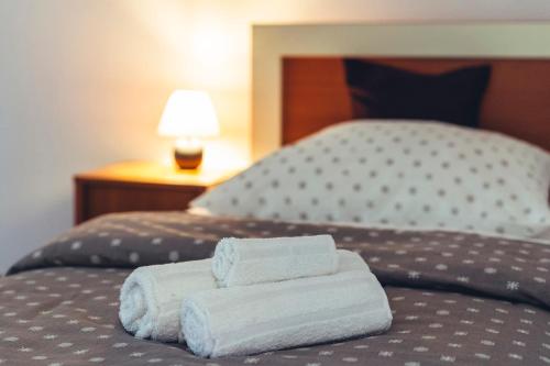 two folded towels sitting on top of a bed at Music Time Apartment in Imotski