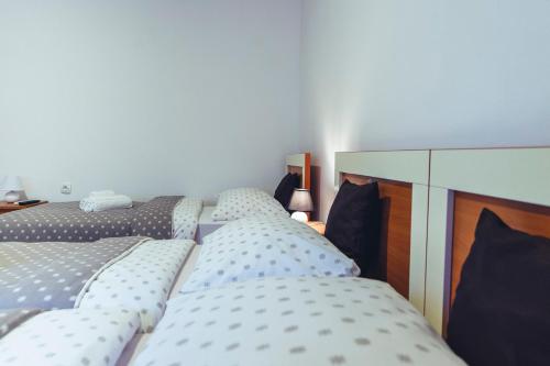 a group of three beds in a room at Music Time Apartment in Imotski