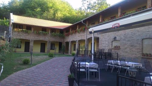 a building with tables and chairs outside of it at Rooms Villa Iva in Ilok