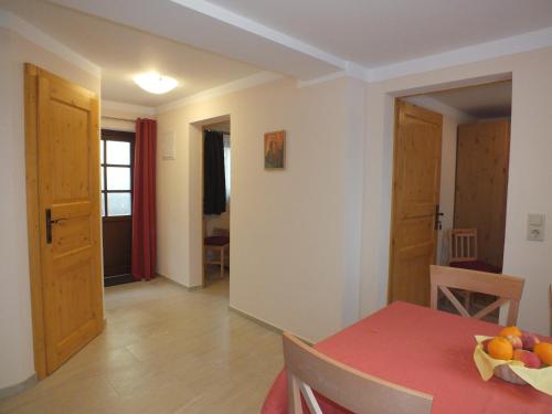 a room with a table with a bowl of fruit on it at Pension am Elberadweg in Radebeul
