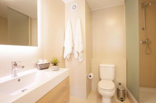 La salle de bains blanche est pourvue de toilettes et d'un lavabo. dans l'établissement Lima Walking Apartments - Central Miraflores, à Lima