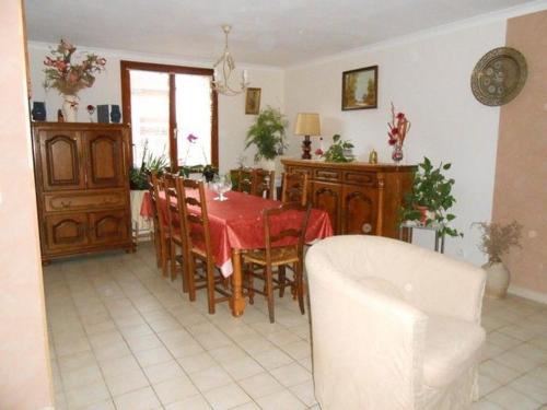a dining room with a red table and chairs at Villa Agapenthe in Cluny