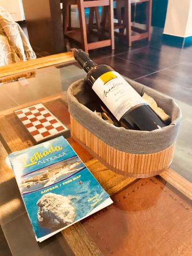a bottle of wine in a basket on a table at Villa Lydia in Nydri