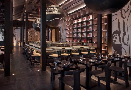 a restaurant with tables and chairs and a bar at SLS LUX Brickell in Miami