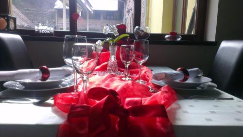 a table with wine glasses and a red table cloth at Rooms Villa Iva in Ilok