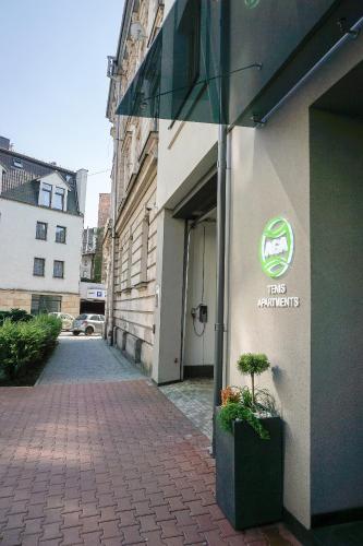 a building with a sign on the side of it at AGA Tenis Apartments by Radwańska in Krakow