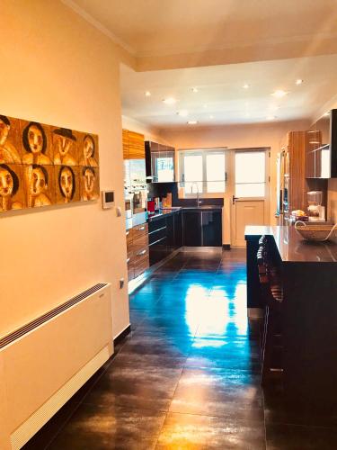 a kitchen with black counters and a blue floor at Villa Lydia in Nydri